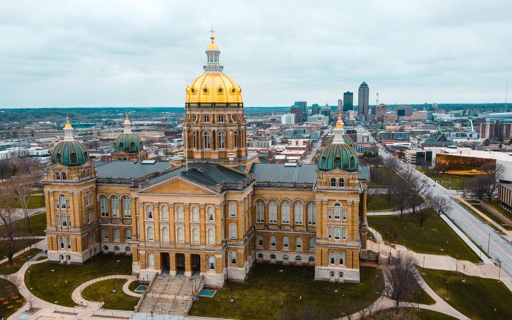 Iowa capital building. long brick with 4 stories and a tower in the middle that is shiny gold metal.